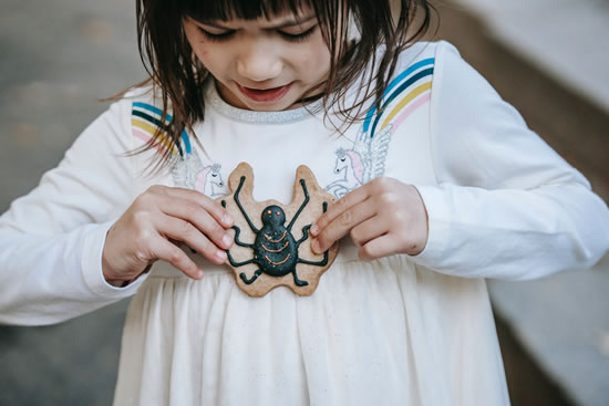 Footprints Foster Care - Girl with a spider biscuit